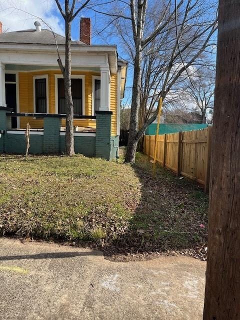 view of side of property with covered porch