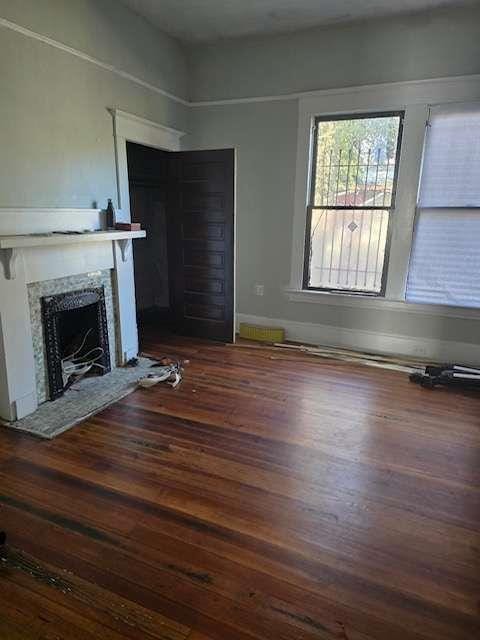 unfurnished living room with dark hardwood / wood-style flooring