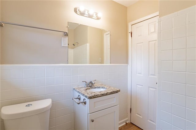 3018 Meadowview Dr SE, Atlanta, GA 30316 - bathroom featuring walk in shower, toilet, tile walls, vanity, and hardwood / wood-style flooring