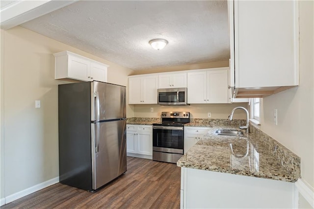 3018 Meadowview Dr SE, Atlanta, GA 30316 - kitchen featuring sink, white cabinets, dark hardwood / wood-style flooring, stainless steel appliances, and light stone countertops