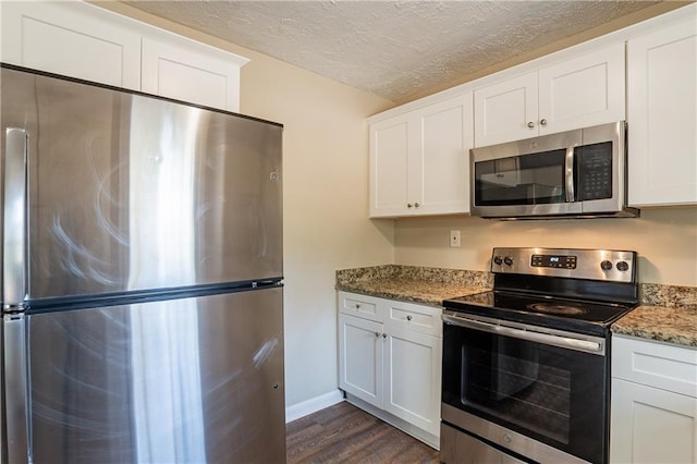 3018 Meadowview Dr SE, Atlanta, GA 30316 - kitchen featuring appliances with stainless steel finishes, stone countertops, white cabinets, and dark hardwood / wood-style floors