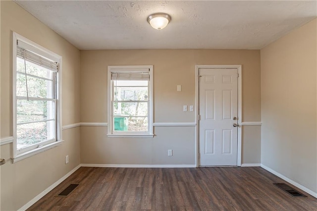 3018 Meadowview Dr SE, Atlanta, GA 30316 - spare room featuring a healthy amount of sunlight, a textured ceiling, and dark hardwood / wood-style flooring