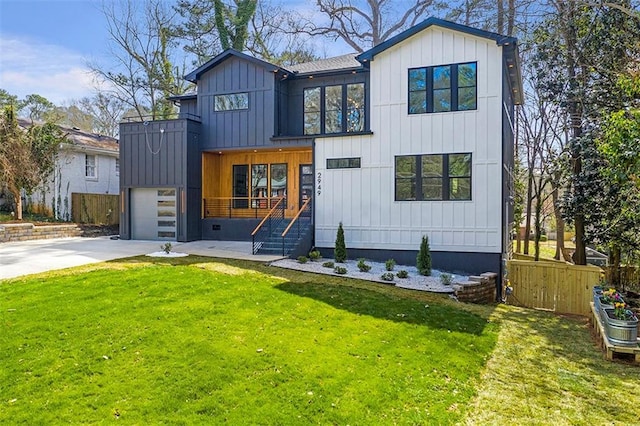 modern inspired farmhouse featuring fence, driveway, a front lawn, a garage, and board and batten siding