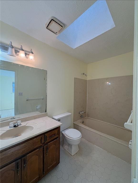 7123 Williamsburg Dr, Riverdale, GA 30274 - full bath featuring shower / washtub combination, toilet, a textured ceiling, vanity, and a skylight