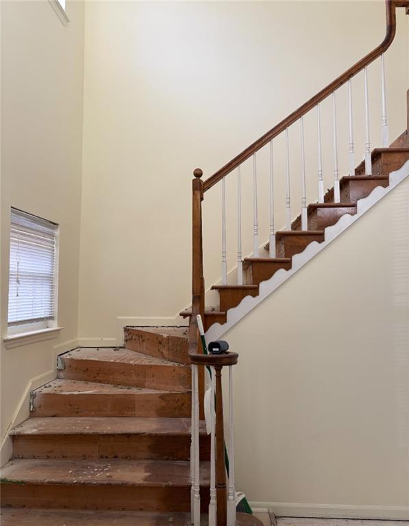 7123 Williamsburg Dr, Riverdale, GA 30274 - stairway with baseboards and a towering ceiling