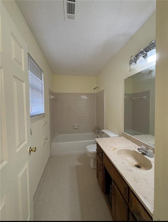7123 Williamsburg Dr, Riverdale, GA 30274 - full bath with toilet, shower / bathing tub combination, a textured ceiling, vanity, and tile patterned flooring
