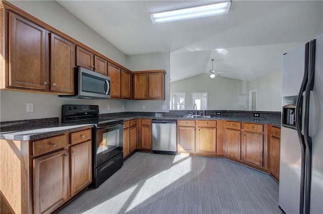 kitchen with sink, vaulted ceiling, ceiling fan, kitchen peninsula, and stainless steel appliances