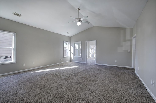 empty room with dark colored carpet, ceiling fan, and vaulted ceiling