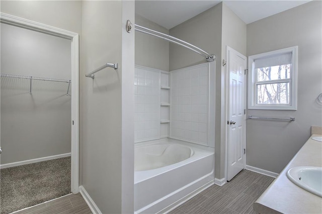 bathroom featuring bathtub / shower combination and vanity