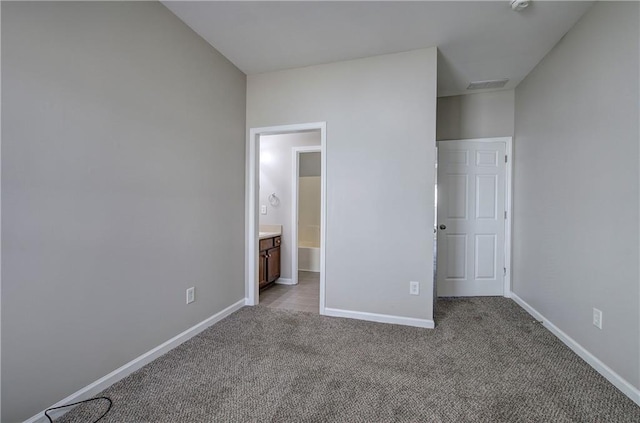 unfurnished bedroom with light carpet and ensuite bath