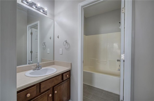 bathroom featuring bathing tub / shower combination and vanity