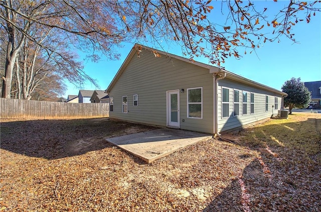 rear view of house with central AC unit and a patio area