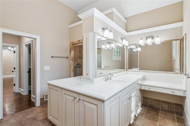 bathroom with vanity and a tile shower
