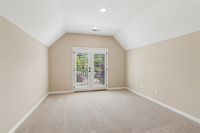 additional living space with light colored carpet, lofted ceiling, baseboards, and recessed lighting
