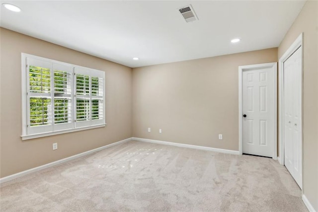 carpeted empty room with baseboards and recessed lighting
