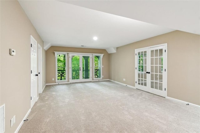 carpeted spare room with french doors and baseboards