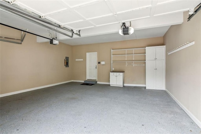 garage featuring electric panel, baseboards, and a garage door opener