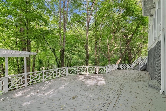 wooden terrace featuring view of scattered trees