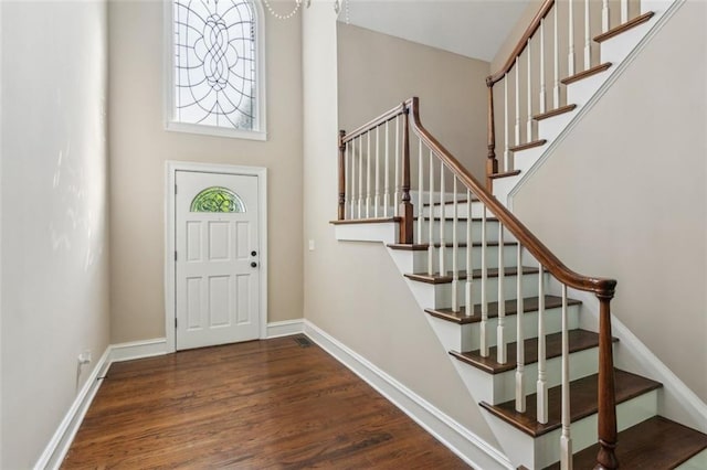 entrance foyer with stairs and wood finished floors