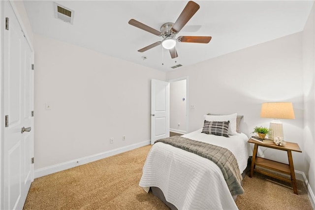 bedroom with light carpet, visible vents, ceiling fan, and baseboards