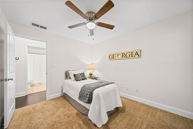 carpeted bedroom featuring visible vents, baseboards, and ceiling fan