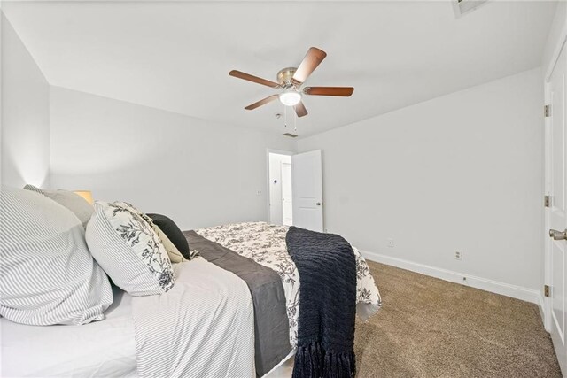 bedroom featuring baseboards, a ceiling fan, and carpet flooring