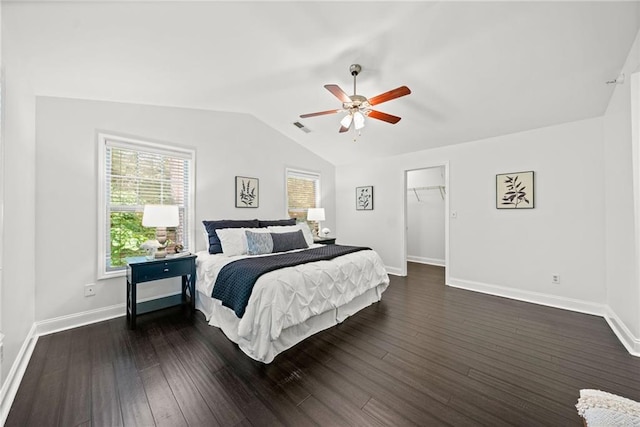 bedroom featuring dark wood finished floors, lofted ceiling, visible vents, and baseboards