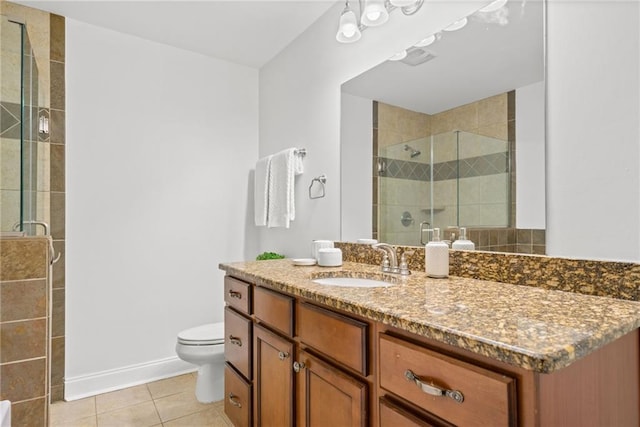 full bath with tile patterned flooring, baseboards, toilet, a stall shower, and vanity