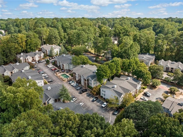 drone / aerial view featuring a view of trees and a residential view