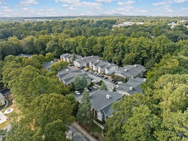 drone / aerial view featuring a forest view and a residential view