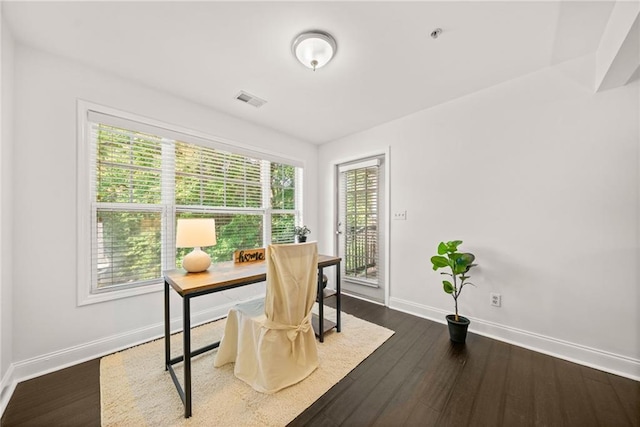 office area with visible vents, baseboards, and dark wood-style flooring