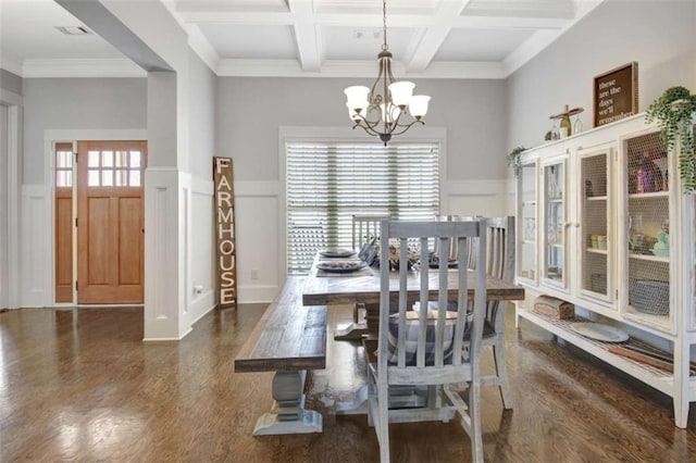 dining room with dark wood finished floors, a decorative wall, a notable chandelier, and beamed ceiling