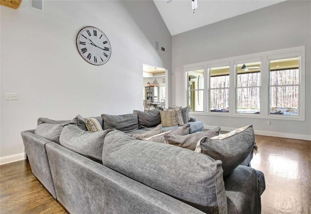 living area featuring baseboards, ceiling fan, and wood finished floors