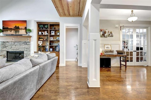 living area with ornamental molding, wood finished floors, a fireplace, wood ceiling, and french doors