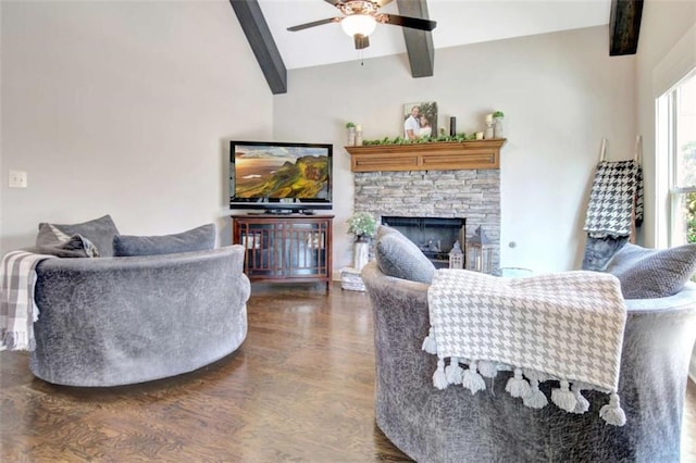 living area with lofted ceiling with beams, a fireplace, a ceiling fan, and dark wood-type flooring
