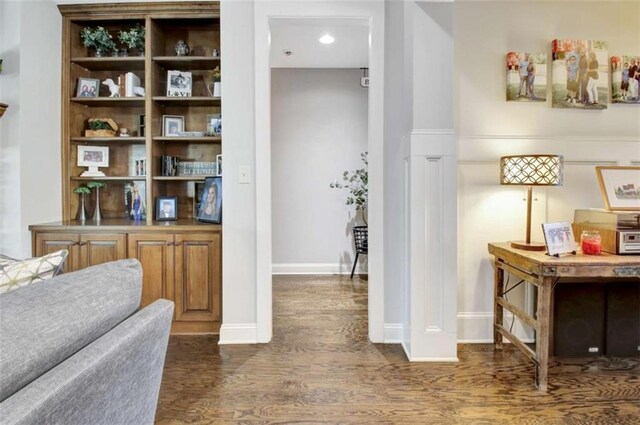 interior space featuring baseboards and wood finished floors
