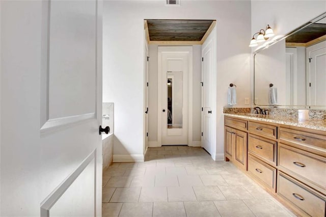 bathroom featuring baseboards, visible vents, tile patterned flooring, and vanity