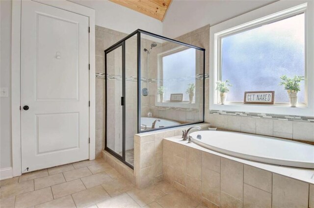 bathroom featuring tile patterned floors, a stall shower, and a garden tub