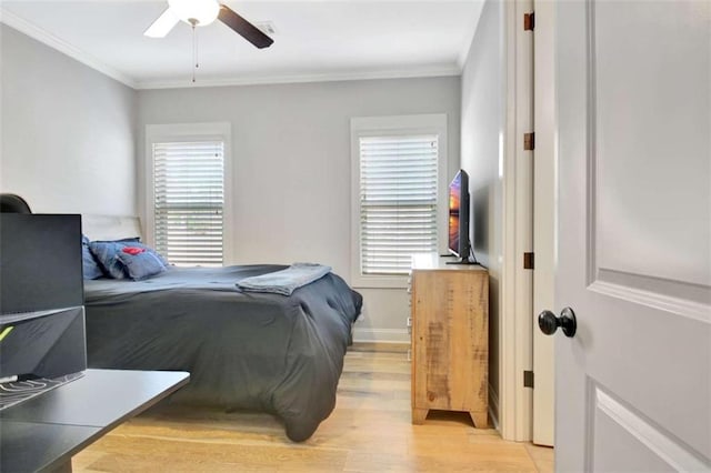 bedroom with baseboards, ornamental molding, light wood finished floors, and a ceiling fan