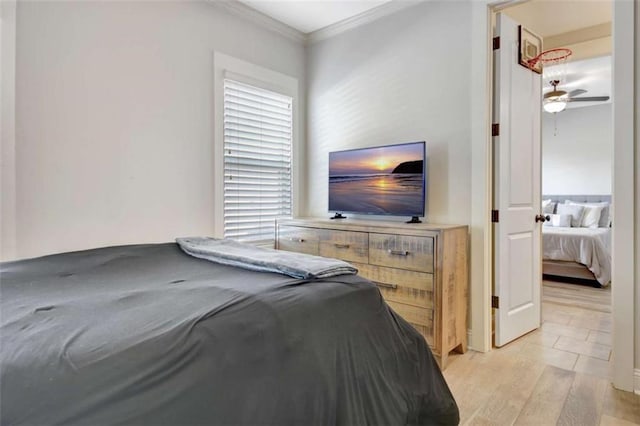 bedroom with crown molding and light wood-style flooring