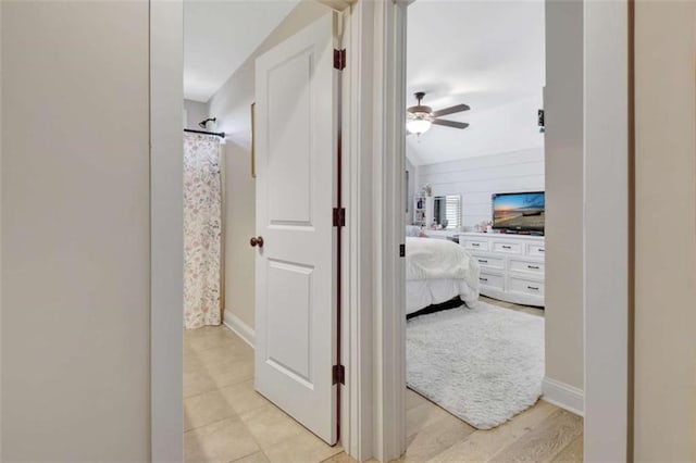 hall featuring baseboards