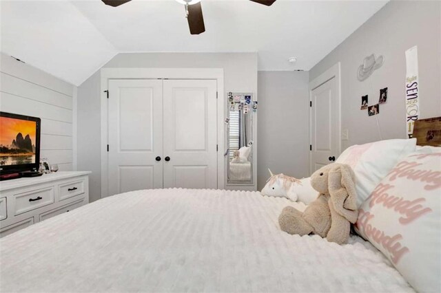 bedroom with a closet, a ceiling fan, and lofted ceiling
