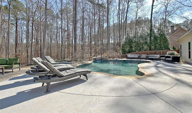 pool with fence, an outdoor hangout area, and a patio area