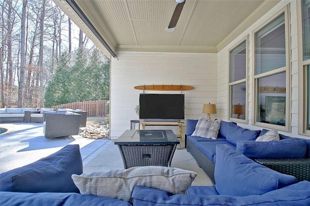 view of patio featuring fence, an outdoor living space, and a ceiling fan