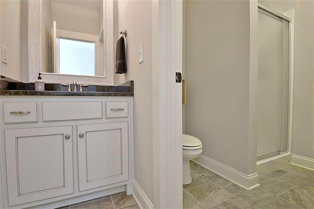 bathroom featuring baseboards, a shower stall, and toilet