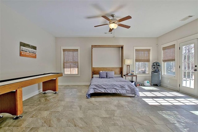 bedroom with visible vents, stone finish flooring, access to outside, and multiple windows