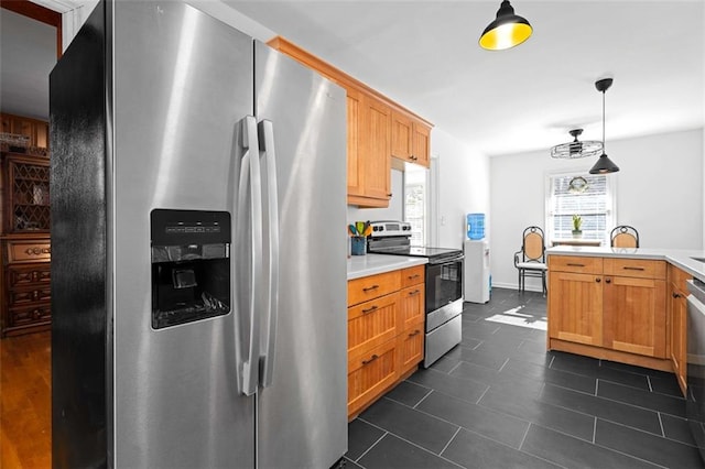 kitchen with hanging light fixtures, stainless steel appliances, and light countertops