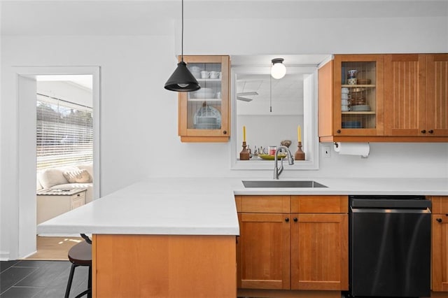 kitchen with a peninsula, a sink, light countertops, dishwasher, and glass insert cabinets