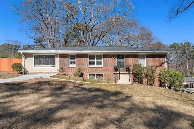 ranch-style home with brick siding, a front yard, and fence