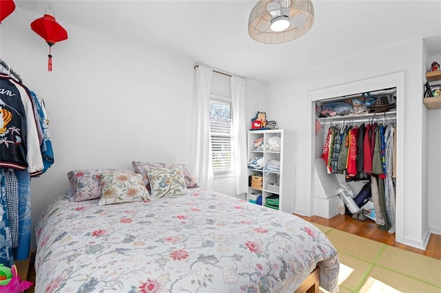 bedroom with a closet and wood finished floors